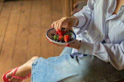 Fresh strawberries served in a ceramic bowl, capturing a simple and healthy lifestyle moment in a rustic countryside setting.
